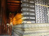 
Also known as the Temple of the Reclining Buddha, Wat Po was built by Rama I in the 16C and is the oldest and largest Buddhist temple in Bangkok. The enormous Reclining Buddha is 46m long and 15m high, with each foot 3m high and 5m long. The statue is brick, covered with layers of plaster, and gold leaf. The most striking part of the statue is its soles, which are decorated with 108 auspicious patterns inlaid with mother-of-pearl.
